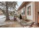 Quaint front entrance with cozy outdoor seating, a charming walkway, and a welcoming, tree-lined neighborhood at 841 Crisman Dr # 9, Longmont, CO 80501