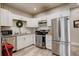 Well-lit kitchen boasts white cabinets, stainless steel appliances, and elegant subway tile backsplash at 841 Crisman Dr # 9, Longmont, CO 80501