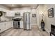 Modern kitchen featuring stainless steel appliances, sleek white cabinetry, and stylish wood-look flooring at 841 Crisman Dr # 9, Longmont, CO 80501