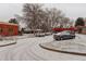 Snowy parking lot of a well-maintained building featuring multiple parked vehicles at 841 Crisman Dr # 9, Longmont, CO 80501