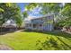 Spacious backyard featuring lush green lawn, mature trees and wooden fencing at 14625 Vine St, Thornton, CO 80602