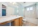 Bright bathroom featuring a single sink vanity and a shower over tub at 14625 Vine St, Thornton, CO 80602