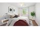 Comfortable bedroom featuring a queen-sized bed, modern decor, and a window with natural light at 14625 Vine St, Thornton, CO 80602