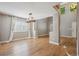 Dining room with hardwood floors, a modern chandelier, and bright windows at 14625 Vine St, Thornton, CO 80602