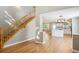 Open living room with stairway and hardwood floors leading into the kitchen at 14625 Vine St, Thornton, CO 80602