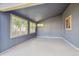 Enclosed sunroom features neutral flooring, painted paneled walls and multiple windows at 14625 Vine St, Thornton, CO 80602