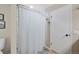 Bright bathroom featuring a door with a silver handle and a shower with a curtain at 10634 Park Mtn, Littleton, CO 80127