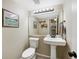 Powder bath featuring a pedestal sink, modern fixtures, and neutral decor at 10634 Park Mtn, Littleton, CO 80127