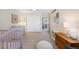 Bedroom featuring a baby crib, dresser, closet, and a bright overhead ceiling fan at 10634 Park Mtn, Littleton, CO 80127