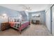 Cozy bedroom features a ceiling fan, a work desk, and a comfortable wrought iron bed at 10634 Park Mtn, Littleton, CO 80127