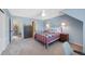Bedroom with neutral walls and carpet, a vintage metal bed frame, and an adjoining library at 10634 Park Mtn, Littleton, CO 80127
