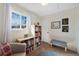 Light-filled bedroom with window, wall art, and built-in shelving for books at 10634 Park Mtn, Littleton, CO 80127