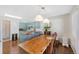 Bright dining area showcasing a wooden table, modern lighting fixtures, and convenient access to the kitchen at 10634 Park Mtn, Littleton, CO 80127