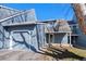 Charming townhome with an attached two-car garage, inviting covered porch and well-manicured lawn at 10634 Park Mtn, Littleton, CO 80127