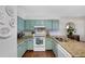 Bright kitchen features blue cabinets, granite countertops, and stainless steel appliances at 10634 Park Mtn, Littleton, CO 80127