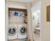 Bright laundry room with washer, dryer, and shelf space at 10634 Park Mtn, Littleton, CO 80127