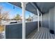 Back porch with string lights strung across the roofline overlooking a well-manicured lawn at 10634 Park Mtn, Littleton, CO 80127