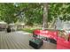 Back deck with an outdoor sectional sofa and coffee table overlooking the backyard at 3380 S Ogden St, Englewood, CO 80113