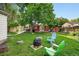 Expansive backyard featuring lush lawn, mature trees, fire pit, and access ramp to the house, great for outdoor entertaining at 3380 S Ogden St, Englewood, CO 80113