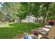 Spacious backyard with a lush lawn, trees, garden and back deck at 3380 S Ogden St, Englewood, CO 80113