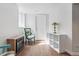 Finished basement area with a green chair, lamp, small fireplace and wood flooring at 3380 S Ogden St, Englewood, CO 80113
