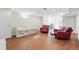 Finished basement area with a daybed, red leather armchairs, and wood flooring at 3380 S Ogden St, Englewood, CO 80113