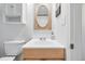 Comfortable bathroom featuring a wood vanity and oval mirror at 3380 S Ogden St, Englewood, CO 80113
