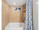 Neutral tiled bathroom with a shower-tub combination at 3380 S Ogden St, Englewood, CO 80113