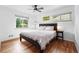 Bedroom with a ceiling fan, hardwood floors, and two windows at 3380 S Ogden St, Englewood, CO 80113