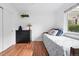 Inviting bedroom with hardwood floors, soft lighting, and a dresser at 3380 S Ogden St, Englewood, CO 80113