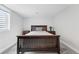 Bright bedroom featuring a dark wood bed frame, side tables, and a window at 3380 S Ogden St, Englewood, CO 80113