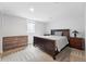 Charming bedroom with wood furniture and a soft, patterned comforter at 3380 S Ogden St, Englewood, CO 80113