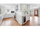 Bright, all-white kitchen featuring stainless steel appliances, ample counter space, and modern cabinetry at 3380 S Ogden St, Englewood, CO 80113