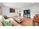 Spacious living room with gleaming hardwood floors, modern furnishings, and ample natural light at 3380 S Ogden St, Englewood, CO 80113