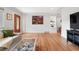 Open-concept living room with hardwood floors, neutral decor, and comfortable seating arrangement at 3380 S Ogden St, Englewood, CO 80113