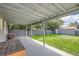 Expansive backyard with a covered patio, lush lawn, and a storage shed at 1309 Jamaica St, Aurora, CO 80010