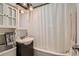 Well-lit bathroom with a vanity sink, medicine cabinet, and shower at 1309 Jamaica St, Aurora, CO 80010