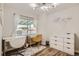 Bright bedroom featuring dual desks, a sunny window, and ample storage with a dresser at 1309 Jamaica St, Aurora, CO 80010