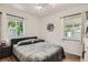 Inviting bedroom with natural light, wood floors, and a comfortable queen-sized bed at 1309 Jamaica St, Aurora, CO 80010