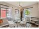 Bright dining room featuring a glass table, modern chairs, and elegant pendant lighting at 1309 Jamaica St, Aurora, CO 80010
