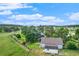 Aerial view of large backyard with a fenced yard, mature trees, and outbuilding at 497 Grey Squirrel Way, Franktown, CO 80116