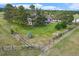 Aerial view of a home with large fenced backyard, mature trees, and well-manicured lawn at 497 Grey Squirrel Way, Franktown, CO 80116