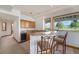 Wet bar features granite countertops, wood cabinets, a wine cooler and seating at the bar at 497 Grey Squirrel Way, Franktown, CO 80116