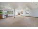 Large carpeted basement with bar area, fireplace, and multiple windows offering bright, natural light at 497 Grey Squirrel Way, Franktown, CO 80116