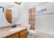 This bathroom offers a tub shower combo, an oval mirror, and neutral tones at 497 Grey Squirrel Way, Franktown, CO 80116