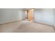 Spacious bedroom with neutral walls, carpet, wood trim, and closet at 497 Grey Squirrel Way, Franktown, CO 80116