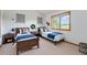 This bedroom offers dual beds, a view of the countryside, and modern decor at 497 Grey Squirrel Way, Franktown, CO 80116