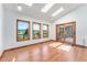 Sunlit dining area with skylights, wood floors, sliding door to deck, and scenic outdoor view at 497 Grey Squirrel Way, Franktown, CO 80116