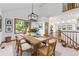 Bright dining room with a modern light fixture, dining table, and a view into the adjacent living area at 497 Grey Squirrel Way, Franktown, CO 80116