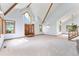 Open foyer featuring high ceilings, exposed beams, a large front door, and ample natural light at 497 Grey Squirrel Way, Franktown, CO 80116